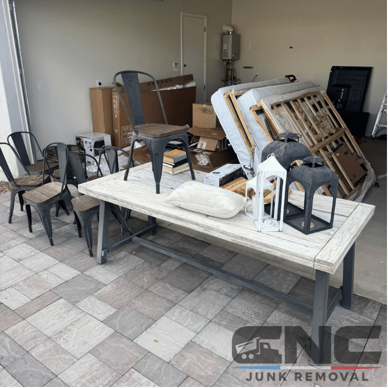 Garage packed with chairs, table, mattress, and household items in Gilbert, AZ